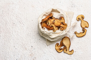 Forest dried edible mushrooms in a linen sack