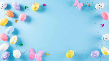 Fototapeta na wymiar Happy easter! Colourful of Easter eggs on pastel blue background. Greetings and presents for Easter Day celebrate time. Flat lay ,top view.