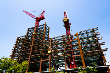 building construction site and cranes with the blue sky background