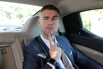 Businessman thinking in back seat 