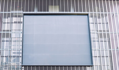 Contemporary building with empty billboard on facade