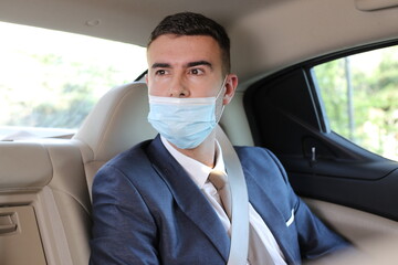 Irresponsible businessman using protective mask the wrong way