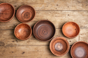 Handmade empty ceramic dishes and plates on wooden background