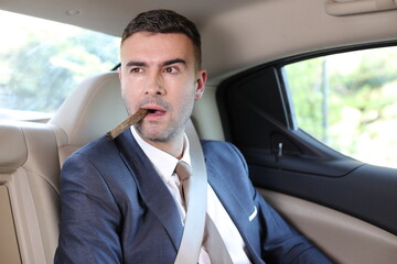 Cuban businessman smoking a cigar in limousine 