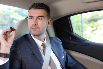 Cuban businessman smoking a cigar in limousine