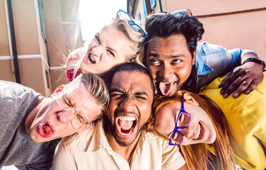 Multiracial millenial people taking selfie sticking out tongue with happy faces - Funny life style...