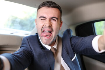 Businessman taking a selfie during road trip