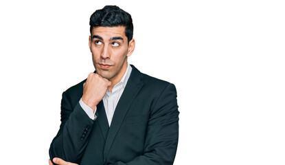 Handsome hispanic man wearing business clothes with hand on chin thinking about question, pensive expression. smiling and thoughtful face. doubt concept.