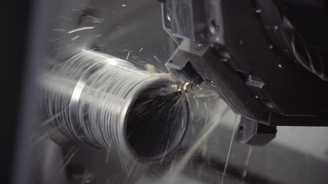 Turning lathe in action. Facing operation of metal blank on turning machine with cutting tool. Old turning lathe machine in turning workshop. Machining high precision mold part by cnc