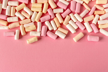 Colorful marshmallows on a pink background. Close-up. Selective focus.