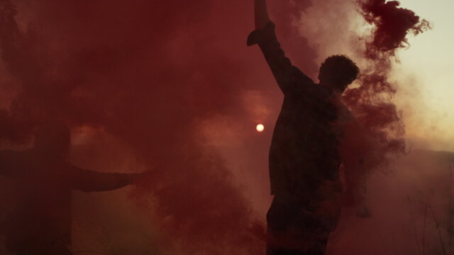 Young couple with smoke flares dancing on top of mountain at sunset - Powered by Adobe