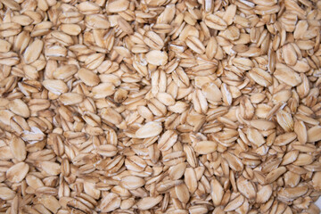 Macro Oatmeal texture. oat flakes food background. Healthy breakfast concept. Muesli cereals.
