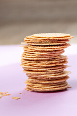 stack of homemade cookies on purple background with natural backlight 