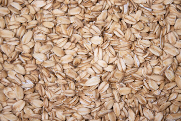 Macro Oatmeal texture. oat flakes food background. Healthy breakfast concept. Muesli cereals.