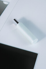 Luxury skincare mockup blue bottle on a mirror and white background, add your own logo, text and design your own brand,