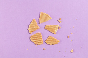 homemade broken cookies on purple background, creative food photography
