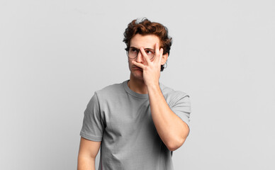 young handsome boy feeling bored, frustrated and sleepy after a tiresome, dull and tedious task,...