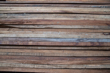 Planks of different types of wood aligned and stacked