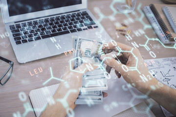 Multi exposure of Formulas drawing hologram and USA dollars bills and man hands. Education