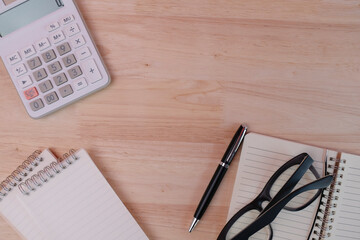 Office supplies that are commonly used on the desk such as pens, calculators, pencils, notebooks, notepads.