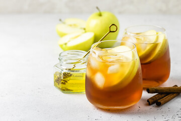 Spiced ginger honey apple iced tea in glasses. Space ofr text.