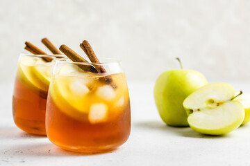 Delicious refreshing summer apple cinnamon iced tea in glasses. Space ofr text.