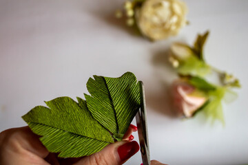 making a bouquet of flowers from paper. the photo was taken in Ukraine in the city of raisins on...
