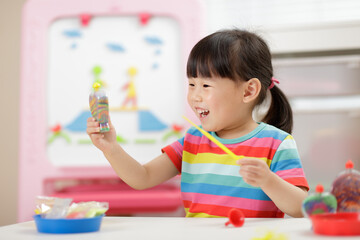 young girl making sand  crafts for homeschooling