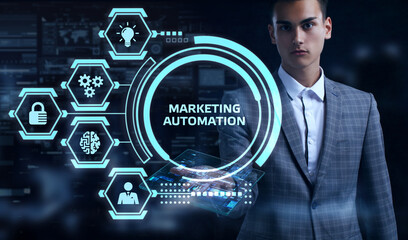 Planning marketing strategy. Business, Technology, Internet and network concept. Young businessman shows the word: Marketing automation