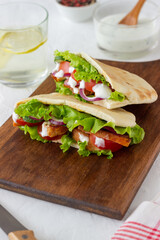 Pita with chicken, tomatoes, cucumbers, onions, salad and white sauce. Doner kebab. Healthy eating. Diet.