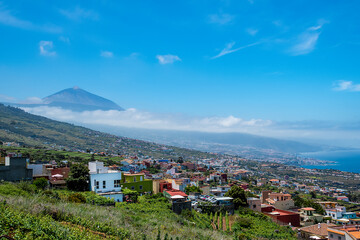 Fototapeta na wymiar Panoramic view of Tenerife island with Puerto de la Cruz City and the volcano Teide on a sunny day. Canary Islands.