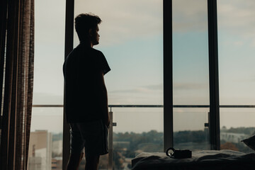 Man staring out of apartment window