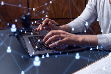 Hands of hr specialist is typing the keyboard in the internet to find the best candidates to create international network in recruitment process. Concept of success. Social media hologram icons.