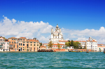 Basilica di Santa Maria della Salute (also known as The Basilica of St Mary of Health), view from the the Grand Canale in Venice, Italy. Italian buildings cityscape. Famous romantic city on water - obrazy, fototapety, plakaty