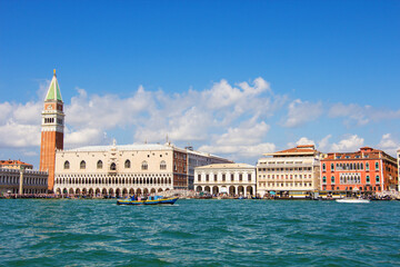The historical Doge's palace and Campanile of Saint Mark's Cathedral on Piazza di San Marco, view from the the Grand Canale in Venice, Italy. Italian buildings cityscape. Famous romantic city on water