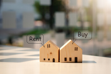Close up two wooden house models with Buy or Rent, copy space.
