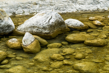 Naklejka na ściany i meble The stones under the pond, close-up as a background.