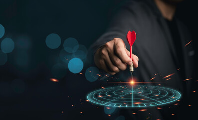 Businessman holding red arrow dart throwing to virtual dartboard on blue bokeh background and copy space, business achievement objective target concept.