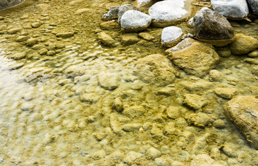 The stones under the pond, close-up as a background.