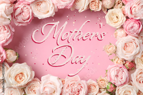 Happy Mother's Day. Beautiful roses on pink background, flat lay