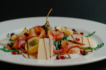 Delicious smoked fish fillet prepared in various ways and arranged on different plates with tasty healthy burger and salad meals