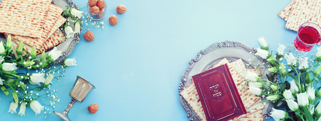 Pesah celebration concept (jewish Passover holiday). Traditional book with text in hebrew: Passover...