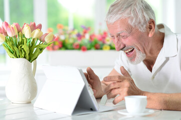 senior man using  laptop  at home