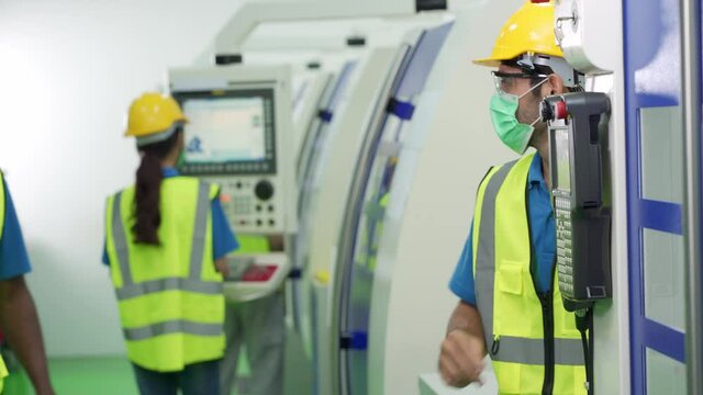 Caucasian male worker wear face mask elbow bump greeting with Caucasian supervisor in factory production line. Concept of new normal working in Covid-19 pandemic and diversity.