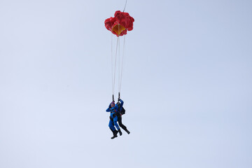 Skydiving. Tandem jump. Man and woman. Winter season.