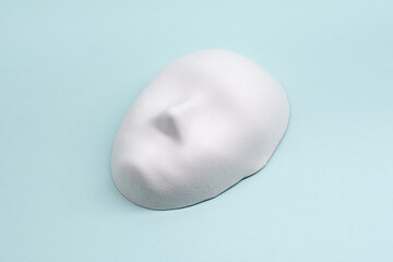 white Venetian mask on a blue background. The concept of the theater. Hypocrisy. Hiding emotions.