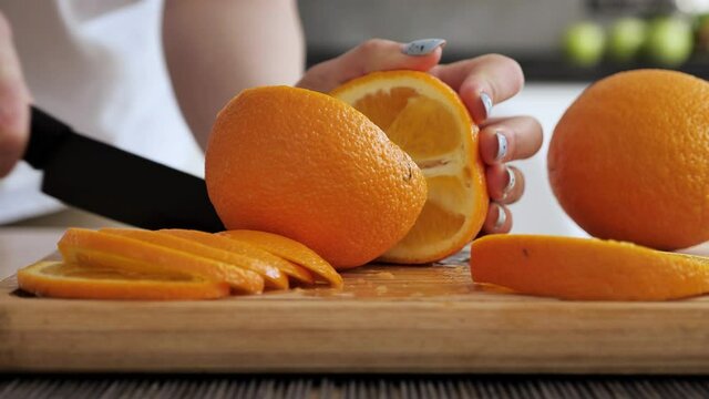 Oranges, orange slices and orange flesh on cutting board