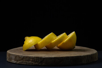 Lemon on a dark background. Sliced lemon on a black background. Creative photo of lemon.