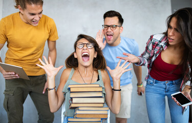 Young stressed, frustrated female student preparing for exams