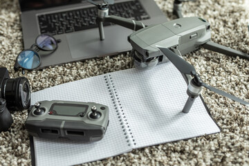 Travel accessories. Drone, notebook, smartphone and laptop, camera and glasses. Top view